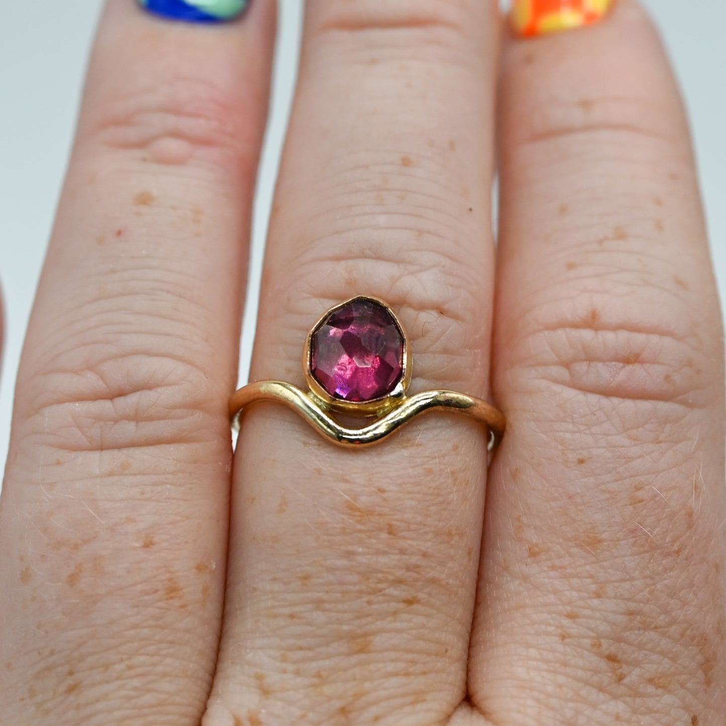 Gold fill garnet in curve band size 7