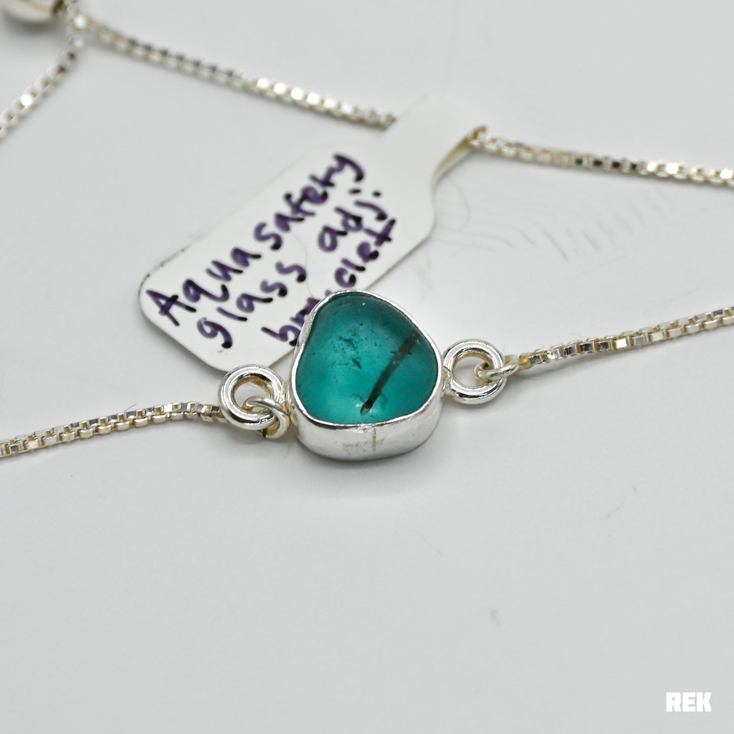 Adjustable bracelet with bright aqua safety sea glass