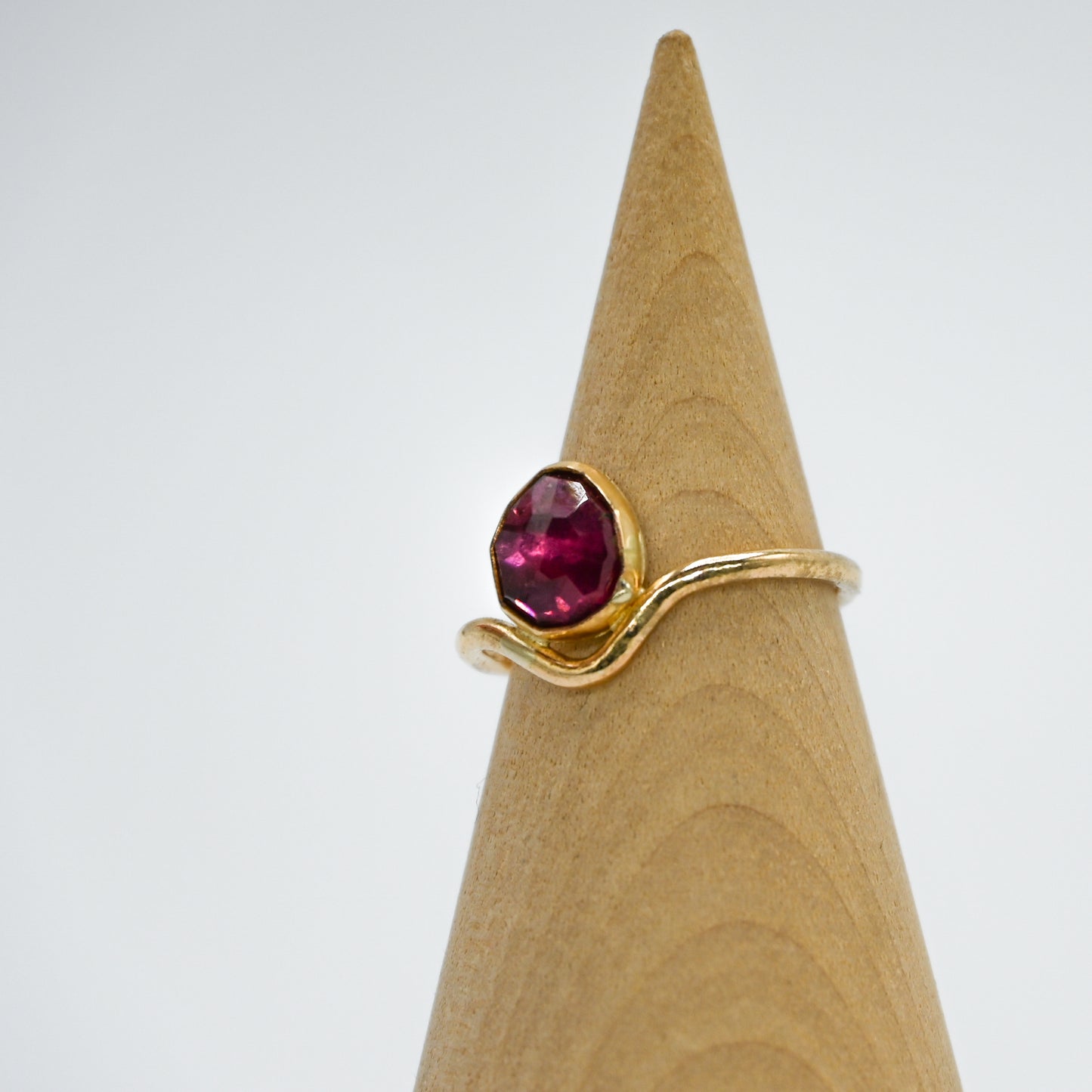 Gold fill garnet in curve band size 7
