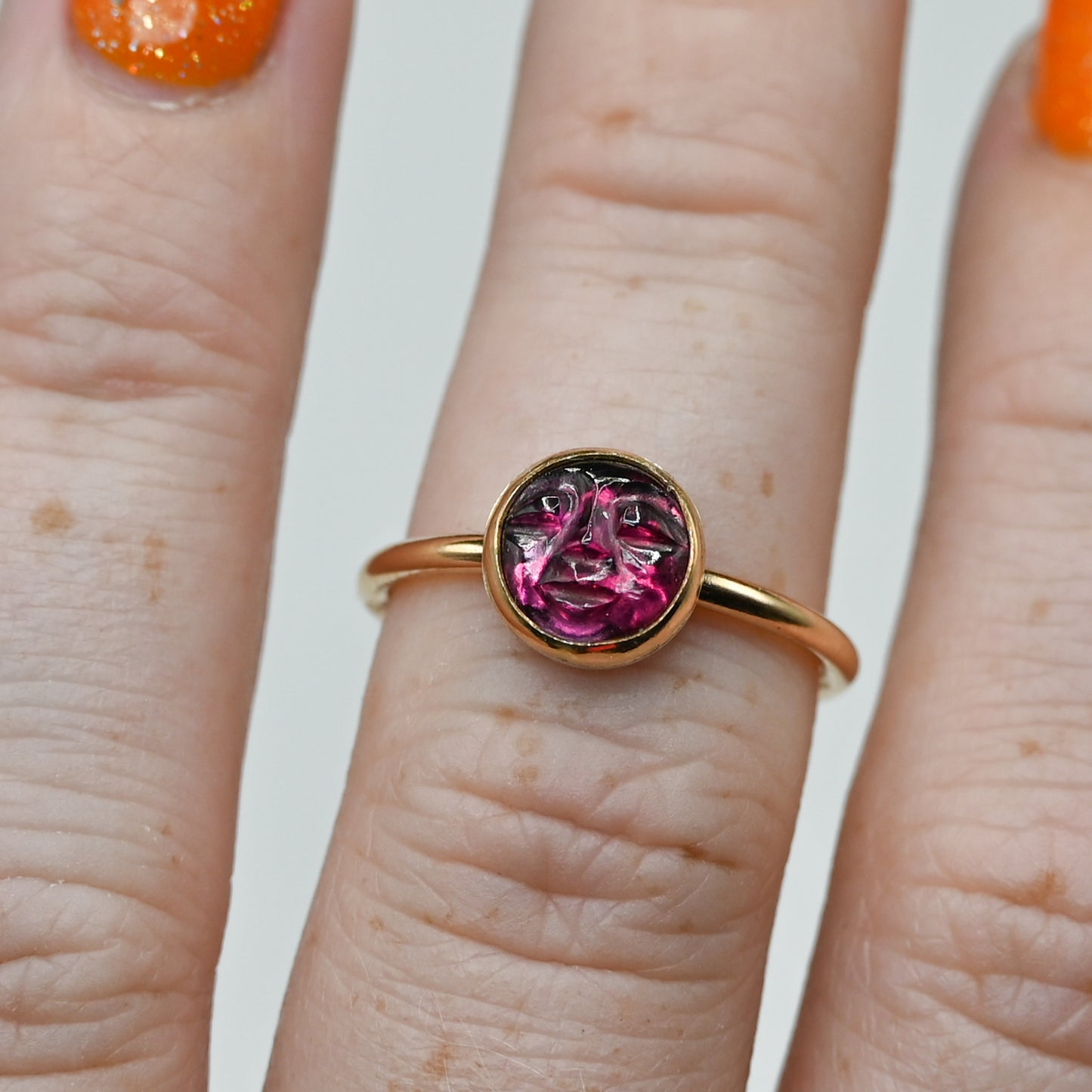 Gold fill garnet carved face size 7